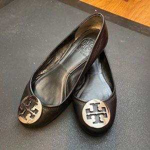 Rare straight backed Tory Burch Reva flat black with silver medallion logo